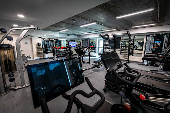 a home gym with weights and cardio equipment