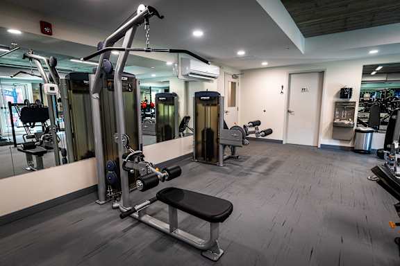 a gym with weights and other equipment in a building