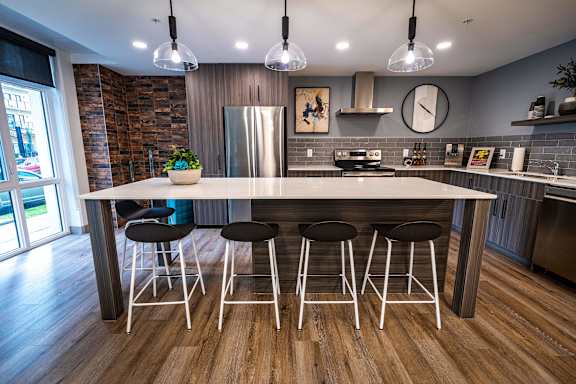 a kitchen with a large island and bar stools