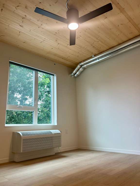 A room with a window and a ceiling fan.