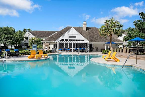 A pool with a building in the background.