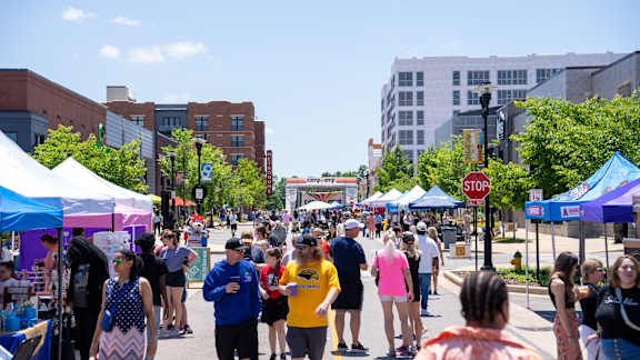 A busy street scene with people walking and shopping at a market1 at Anthem House, Huntsville, AL