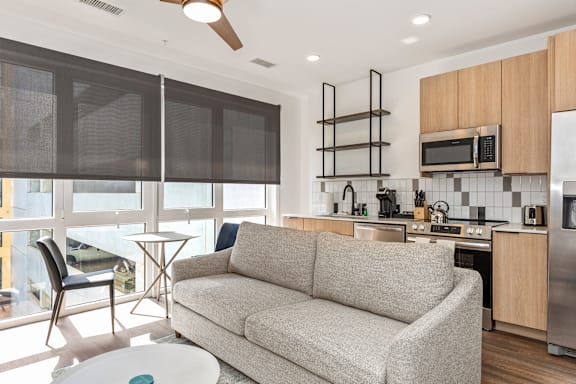 Living Room With Kitchen View at Anthem House Apartments, Huntsville, AL