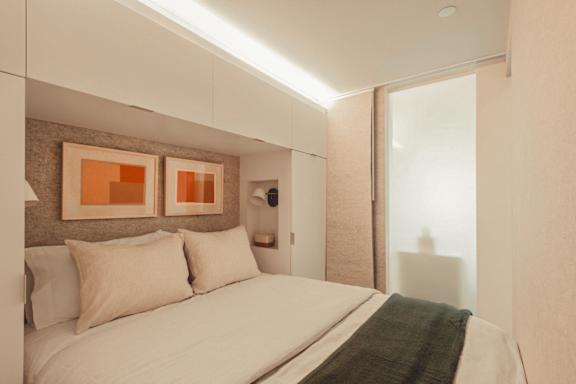 a small bedroom with a bed and a window at Scout Living, powered by Placemakr Apartments, Atlanta