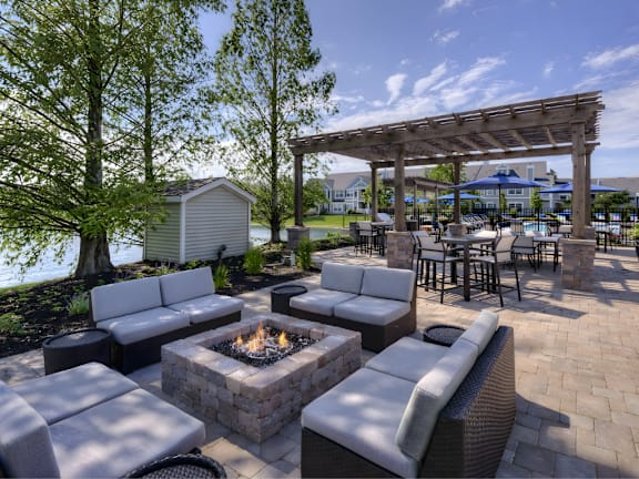 A patio with a fire pit and seating area.