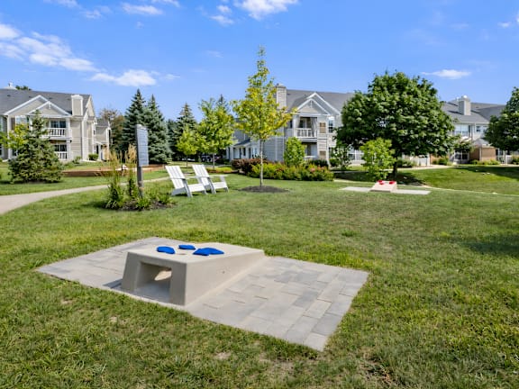 A concrete platform with two blue circles on it is in the middle of a grassy area.