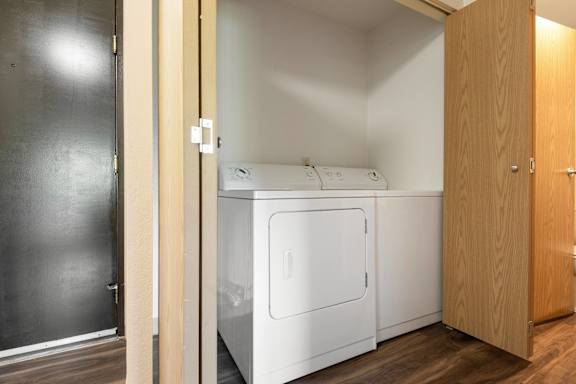 an empty laundry room with a washer and dryer in it at Eagles Landing Apartments, Everett, WA