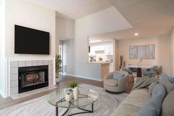 a living room with a fireplace and a tv
