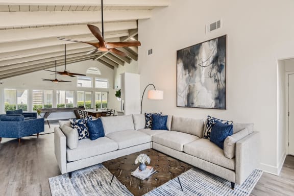 Clubhouse with Large White Couch at Azul Apartments in California, 92545