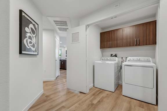 full-size in-unit washer and dryer at The Park apartment homes with overhead cabinetry