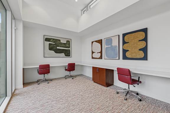 Business center at the Park with plenty of desk space, office chairs and natural lighting for a peaceful work experience.