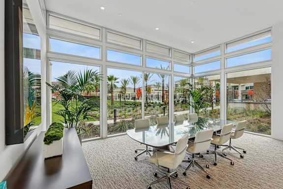 Beautiful conference room at The Park with floor to ceiling windows, carpeted flooring and a conference table.
