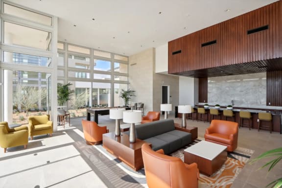 a large lobby with couches and chairs and a table with chairs at The Max on Jefferson Apartments, Murrieta, 92562