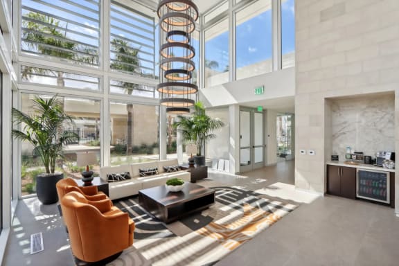 a large lobby with a spiral staircase in the middle of a building at The Max on Jefferson Apartments, Murrieta, California