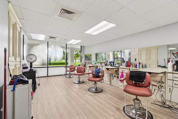 A hair salon with chairs and hairdressing stations at Hampton Apartments, Clearwater