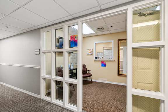 A room with a white door and a brown carpet at Hampton Apartments, Florida, 33759