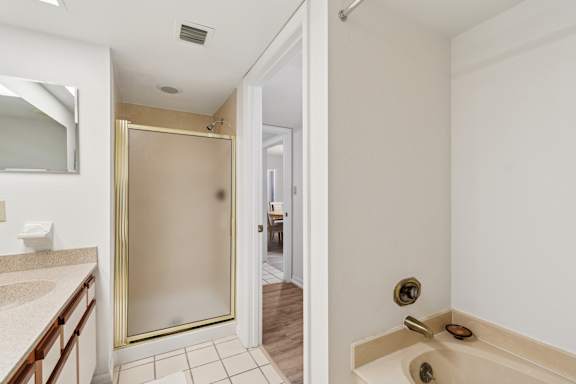 A bathroom with a walk-in shower and a toilet at Hampton Apartments, Clearwater, FL, 33759