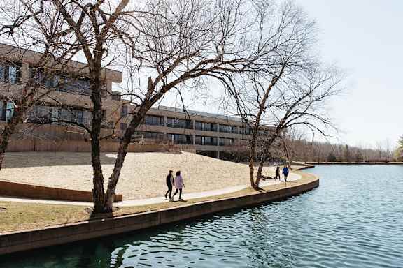 people walking on a path near a body of water at The Residences at Tesson Ridge, Saint Louis, 63128