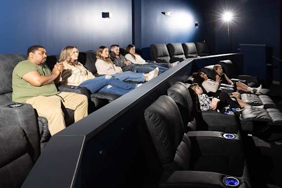 a large group of people sitting in a darkened movie theater at The Residences at Tesson Ridge, Saint Louis, 63128