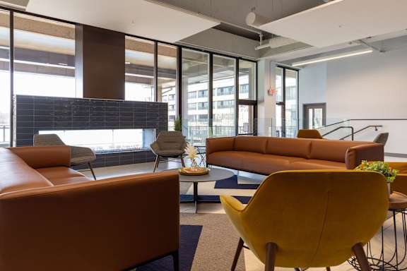 a lobby with couches chairs and a table at The Residences at Tesson Ridge, Missouri, 63128