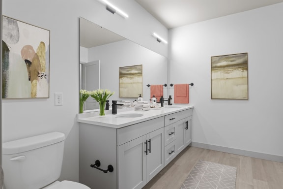 a white bathroom with a large mirror and a sink at The Residences at Tesson Ridge, Saint Louis, MO, 63128