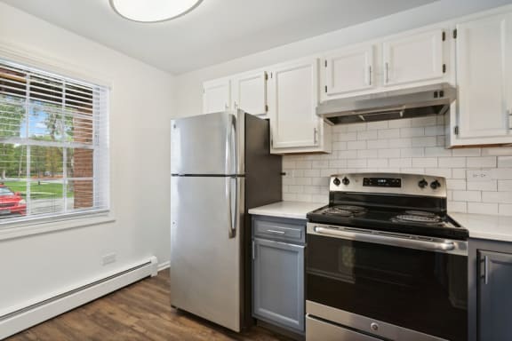 a kitchen with stainless steel appliances and white cabinets