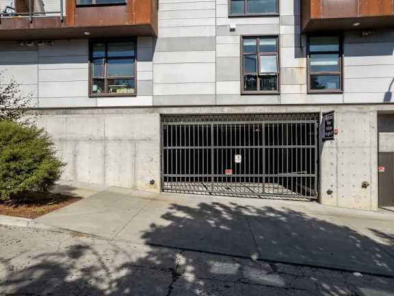 Underground parking garage entrance with metal security gate at Brooklyn Yard Apartments, Portland