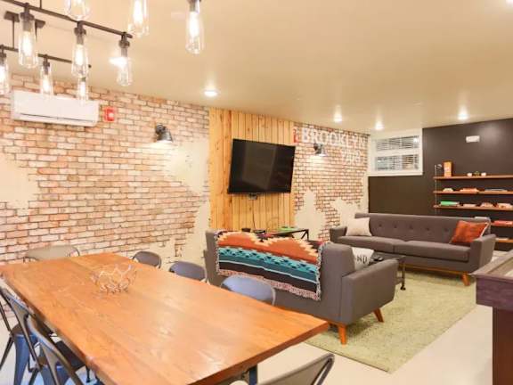 Community lounge with exposed brick and modern furniture at Brooklyn Yard Apartments, Oregon