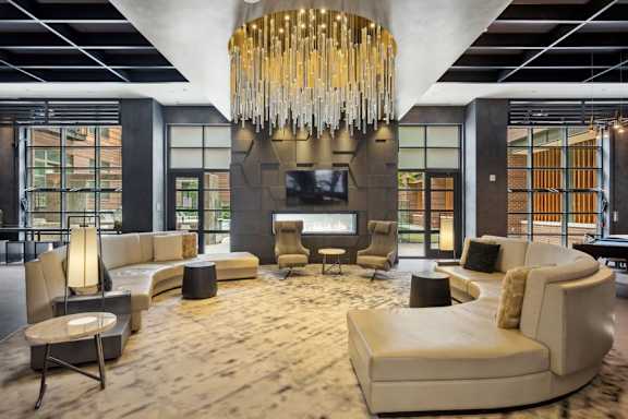 a large living room with a chandelier and a fireplace