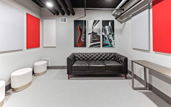 Music themed lounge with leather sofa and artwork at Pure Lowry Apartments, Minneapolis, 55405