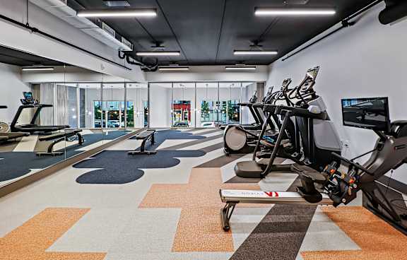 Fitness center with rowing machine and treadmills at Pure Lowry Apartments, Minneapolis
