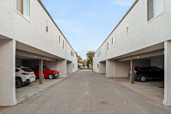 Open parking garages lining central access drive at Shorehaven Townhomes Apartments, Ventura