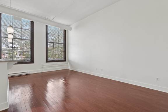 A room with wooden floors and white walls.