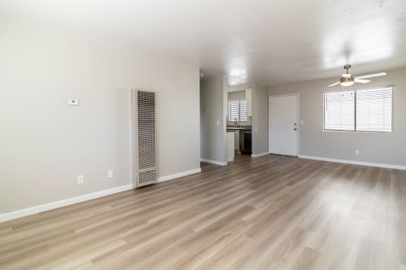 an empty living room with wood flooring and ceiling fan at Alturas Paso Robles Apartment Homes, Paso Robles, CA