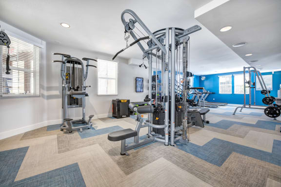 a workout room with a variety of exercise equipment