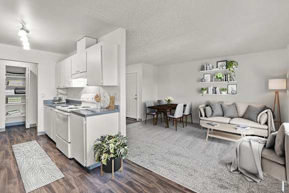 A modern kitchen with a dining table and a couch.