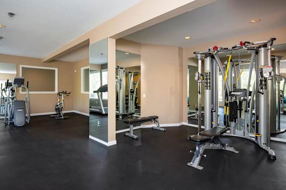 a gym with cardio equipment and weights on the floor at Murrayhill Park, Beaverton, 97008