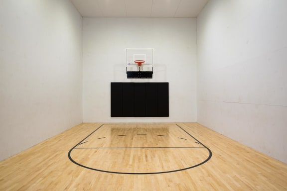 a large room with a basketball court and a scoreboard on the wall at Murrayhill Park, Beaverton, OR