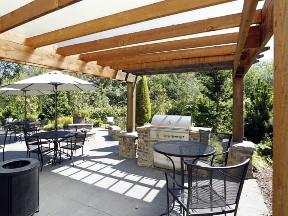 a patio with tables and chairs and a grill at Murrayhill Park, Beaverton Oregon