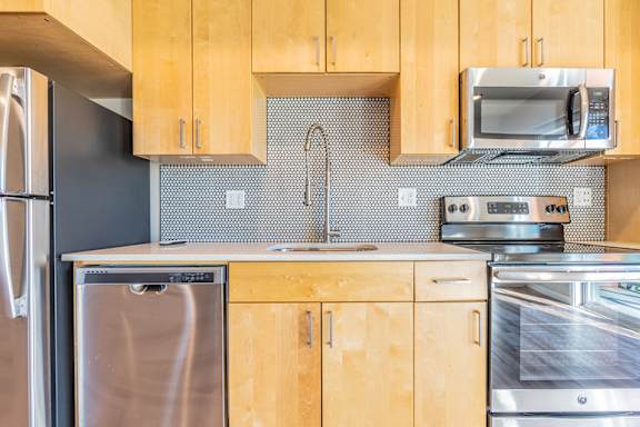 A kitchen with wooden cabinets and stainless steel appliances.