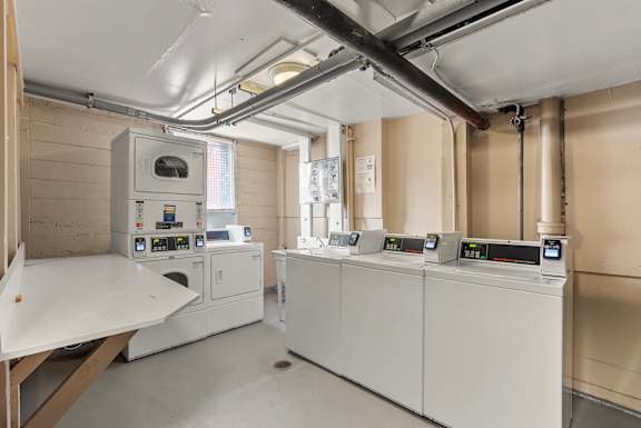 A series of industrial machines are lined up in a room.