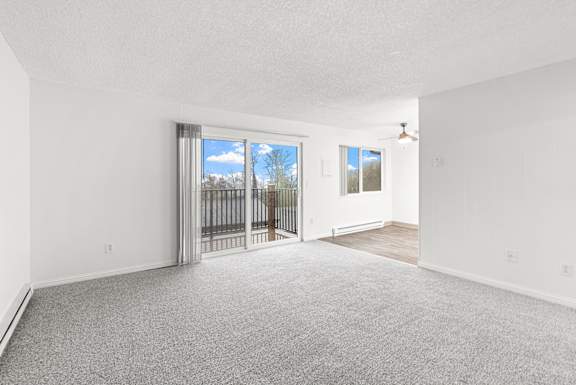 A room with a sliding glass door leading to a balcony.