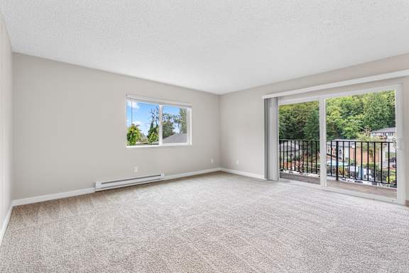 A room with a window and a balcony.
