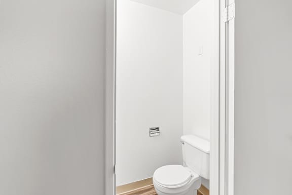 A white toilet in a small bathroom.