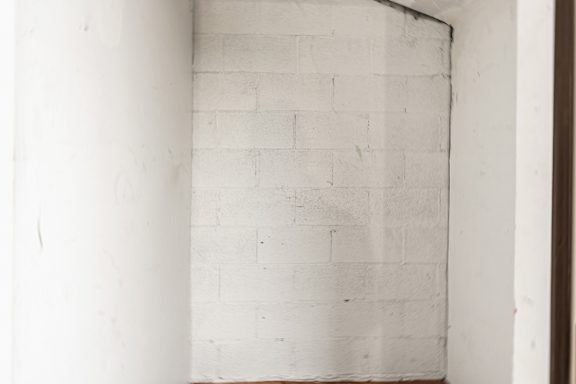 A white brick wall with a crack.
