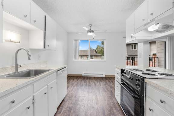 A kitchen with white cabinets and a black stove top oven.