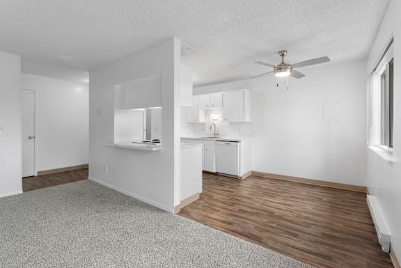 A room with a ceiling fan and a washer and dryer.