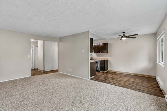 A room with a ceiling fan and a desk with a computer.