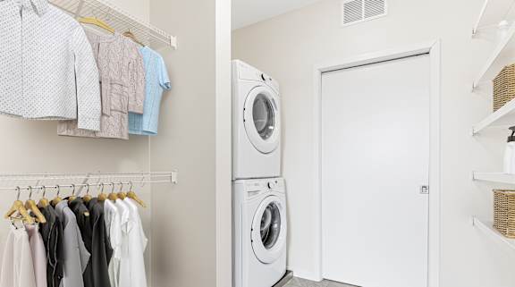 Laundry room with clothes hanging up and washing machine at Elements of Linden Hills, Minneapolis