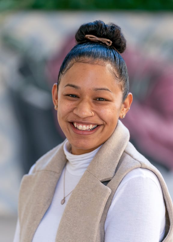 a woman with a blue hair bun smiling